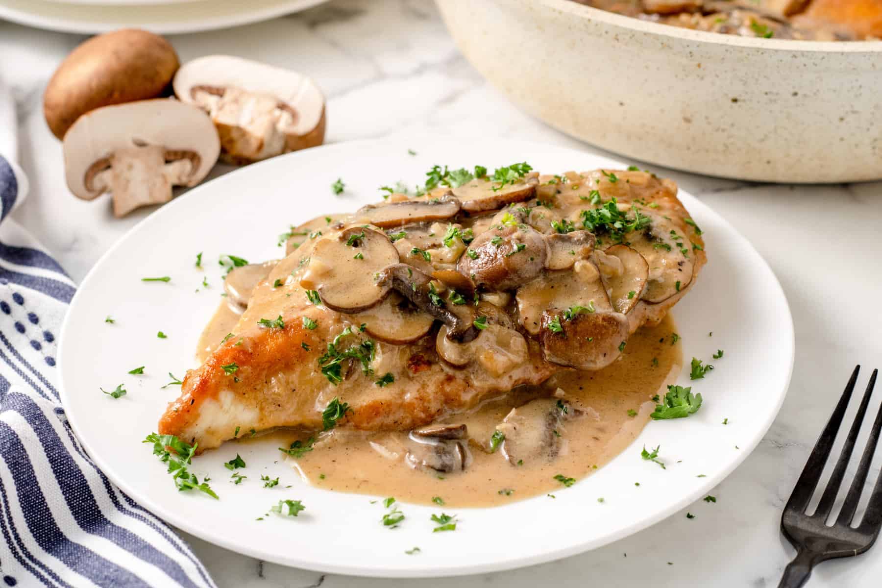 chicken breast on a plate with marsala sauce