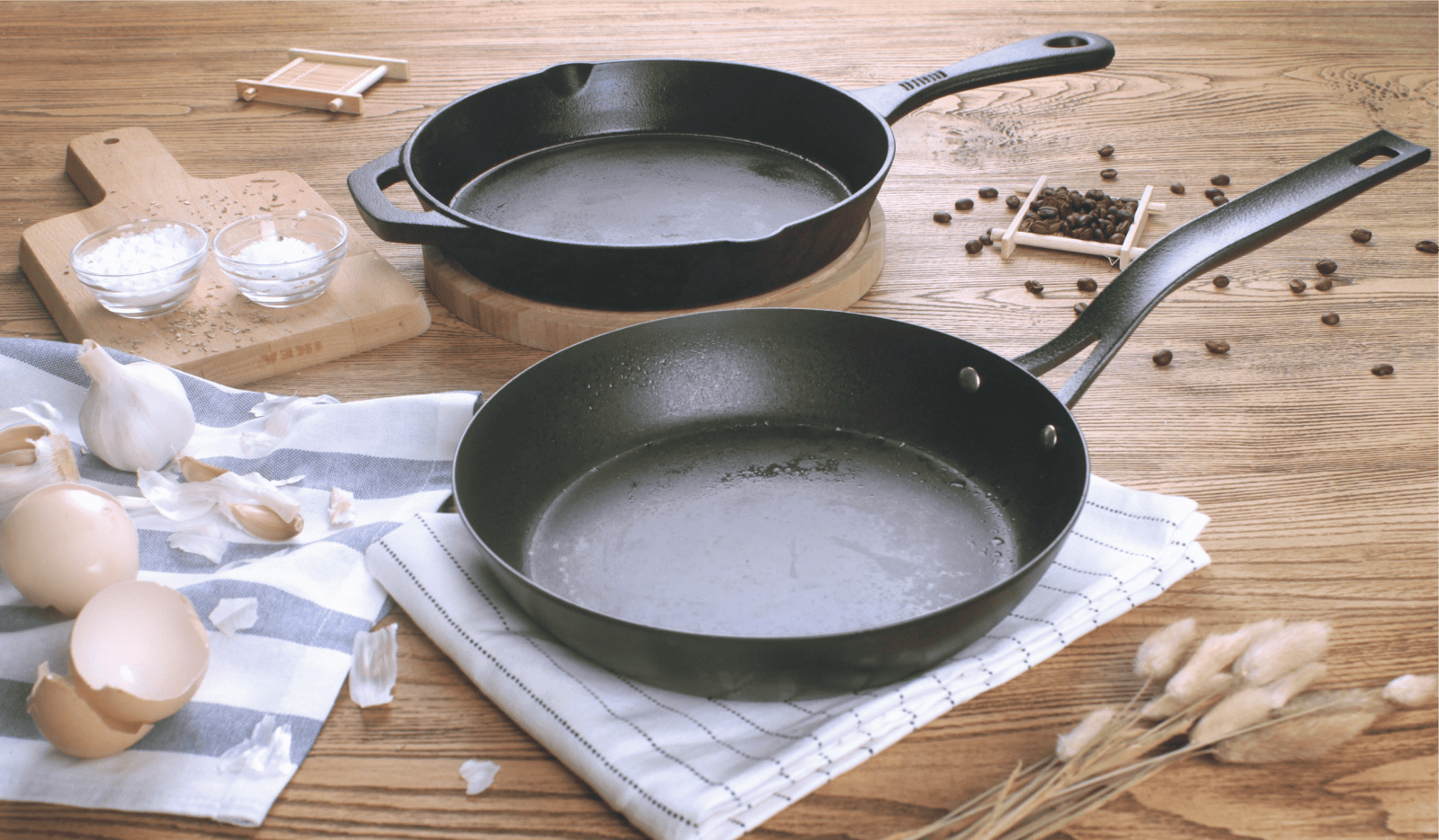 two cast iron saute pans on a wooden background