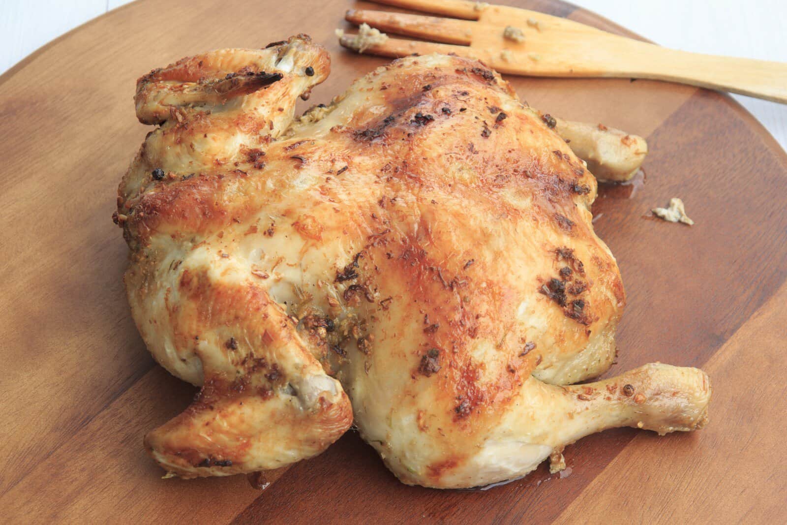 whole chicken on a wooden board