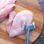 Tenderizing Raw Chicken Breast with a Meat Mallet