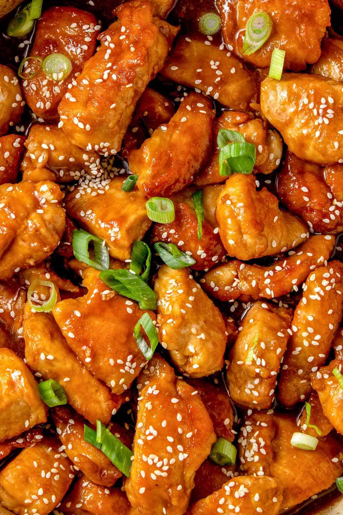 macro photo of sauce with chicken and sesame seeds